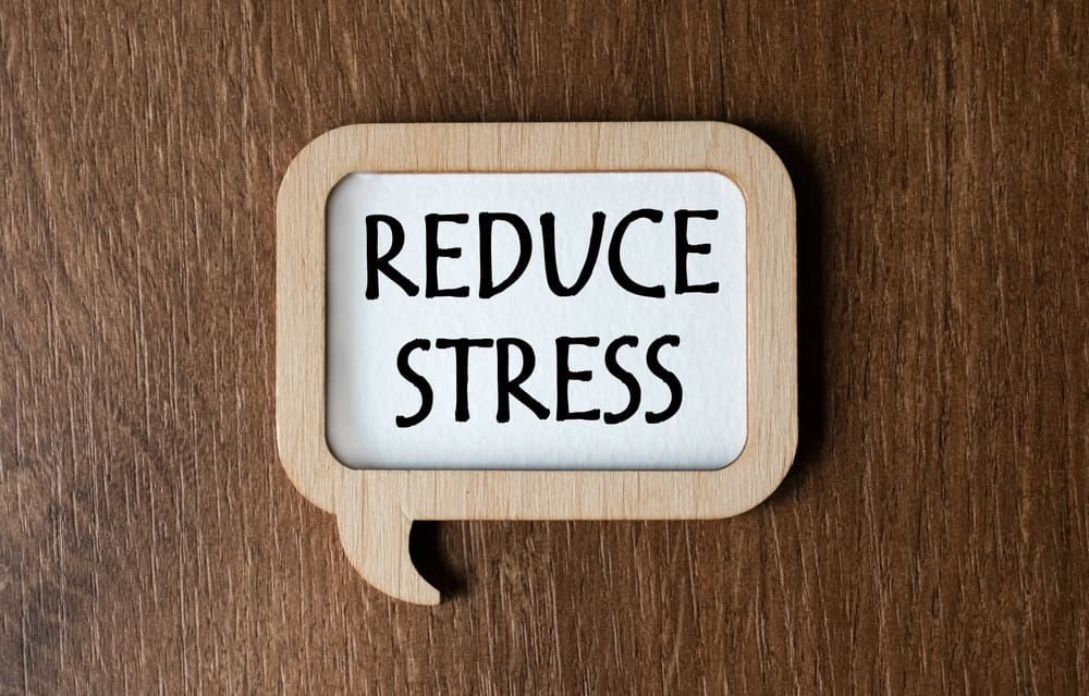 Sign reads reduce stress with wood background